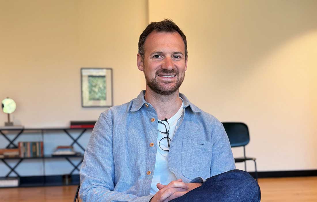 Broghan Smith, Commercial Director, smiling in a modern office setting.