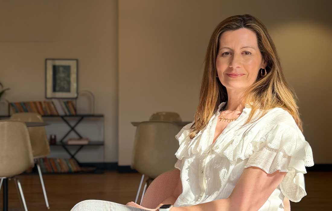 Broghan Smith, Commercial Director, sitting in a modern office setting.